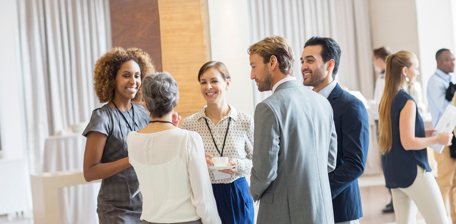 Conference goers chat in a circle