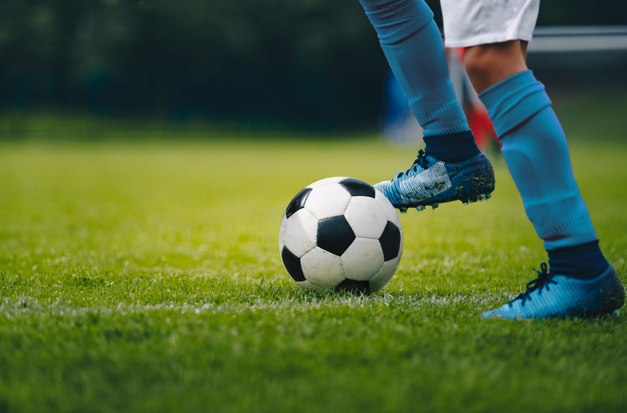 Soccer player stands near ball